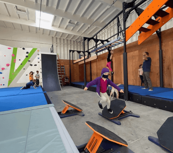 A kid running through the Agility Boulders Kids Ninja Warrior Course.