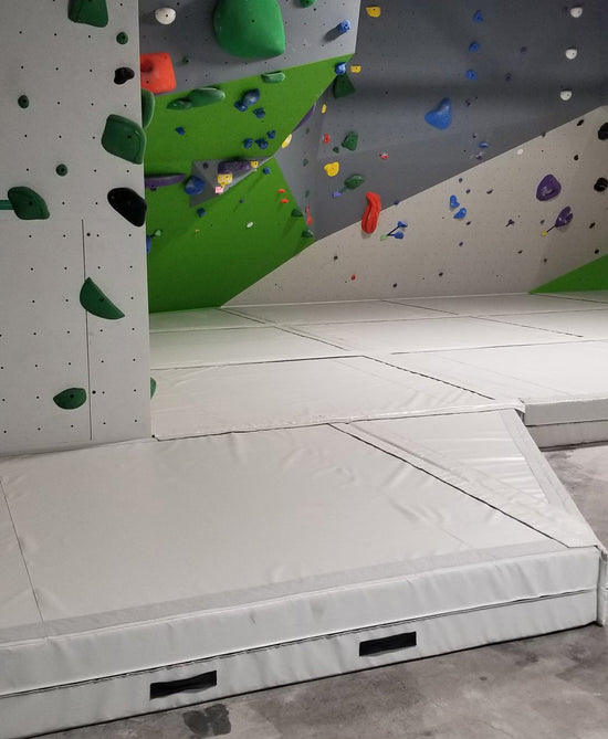 Rock climbing bouldering padded flooring in a climbing gym. 